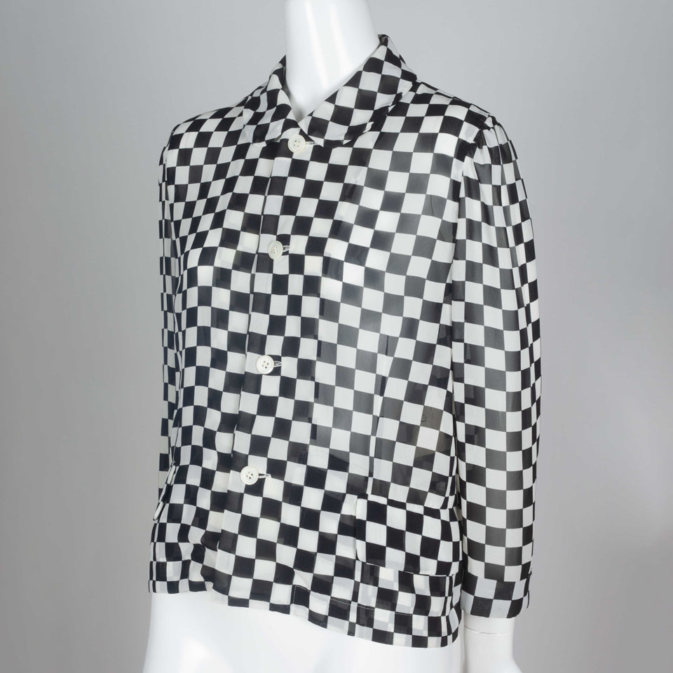 A 1996 chiffon long sleeve blouse from Japan by Comme des Garçons with black and white checkered print and peter pan collar.