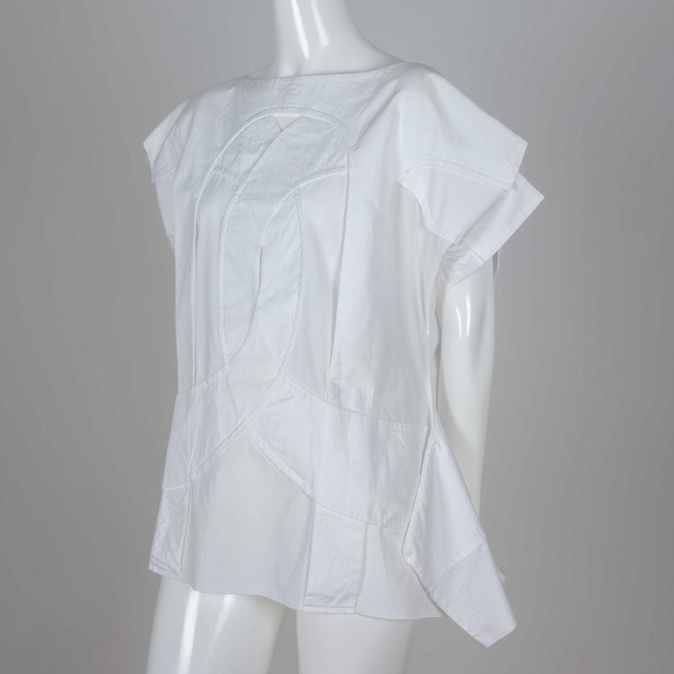 Comme des Garçons 2014 white shirt called "Flat Pack" with overlapping layers of white cotton and an intriguing silhouette.