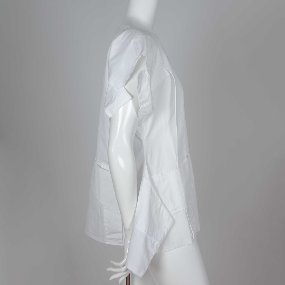 Comme des Garçons 2014 white shirt called "Flat Pack" with overlapping layers of white cotton and an intriguing silhouette.