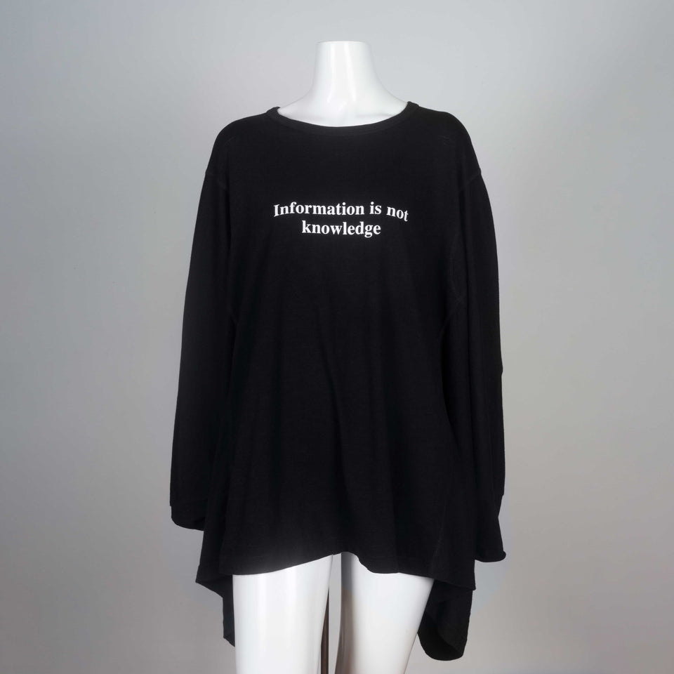 Kimono sleeved black t-shirt from Japan with visible surge stitching and a message in white lettering, "Information is not knowledge."