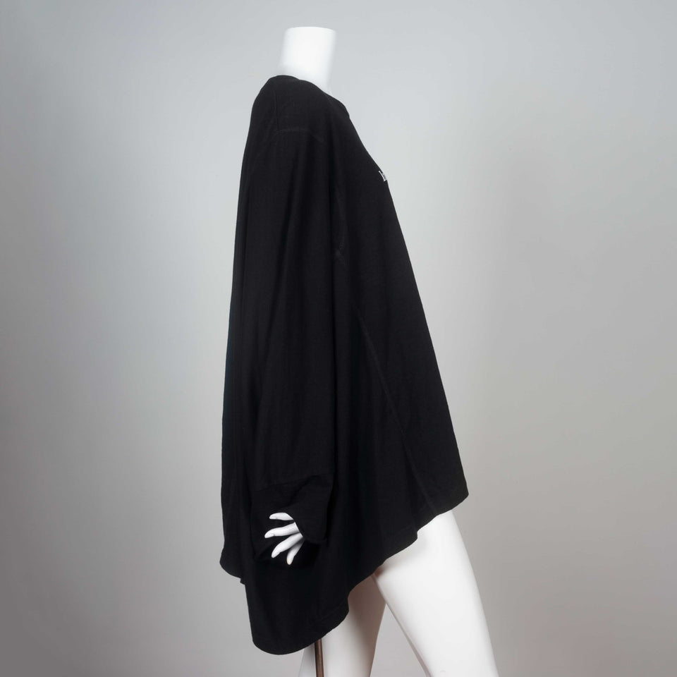 Kimono sleeved black t-shirt from Japan with visible surge stitching and a message in white lettering, "Information is not knowledge."