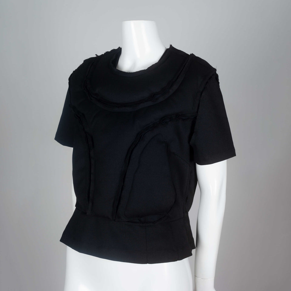 Comme des Garçons 2010 black wool top with padding on chest around collar and on torso.
