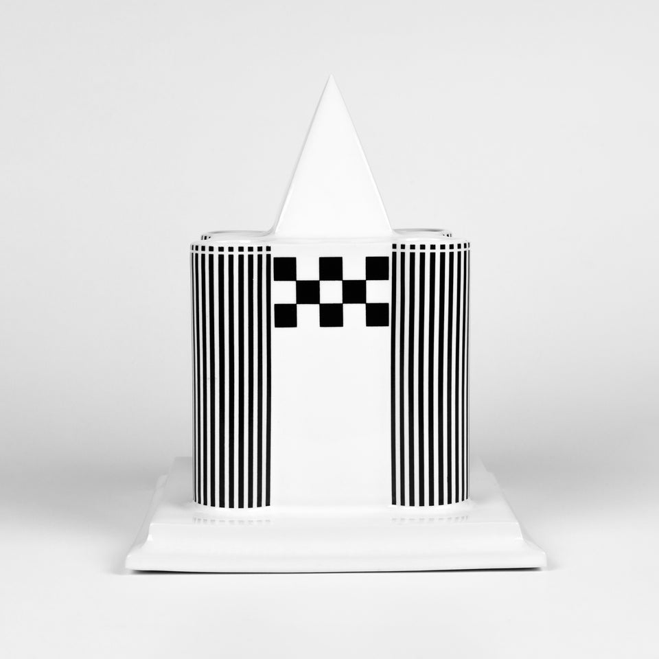 Candle holder in the shape of a Viennese castle in glazed porcelain with black and white painted graphics. 